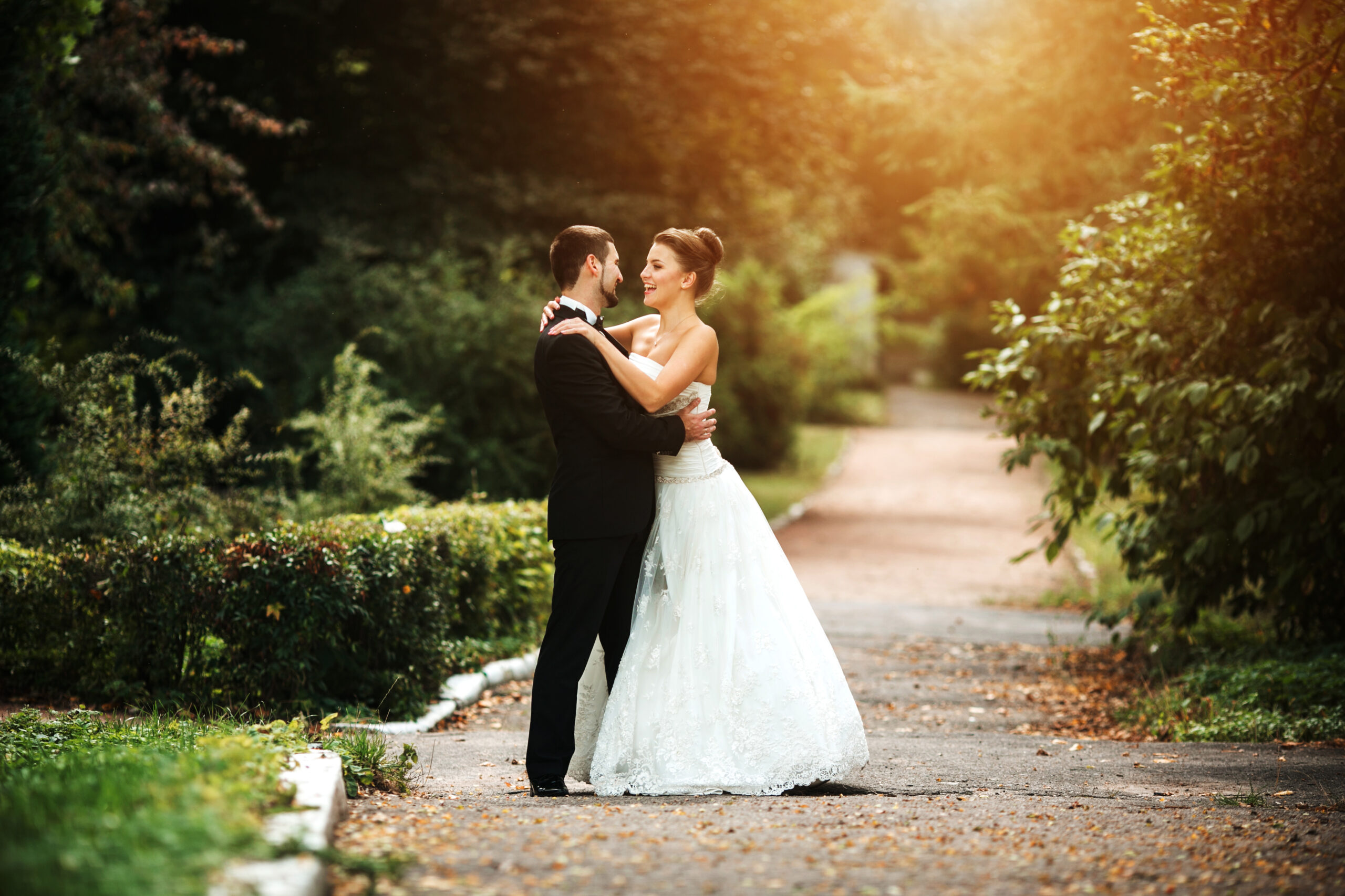 Beautiful wedding couple in each other's arms in the park